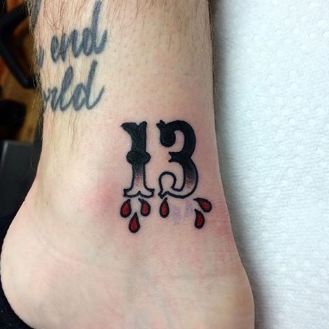 Lucky 13 tattoo on the wrist