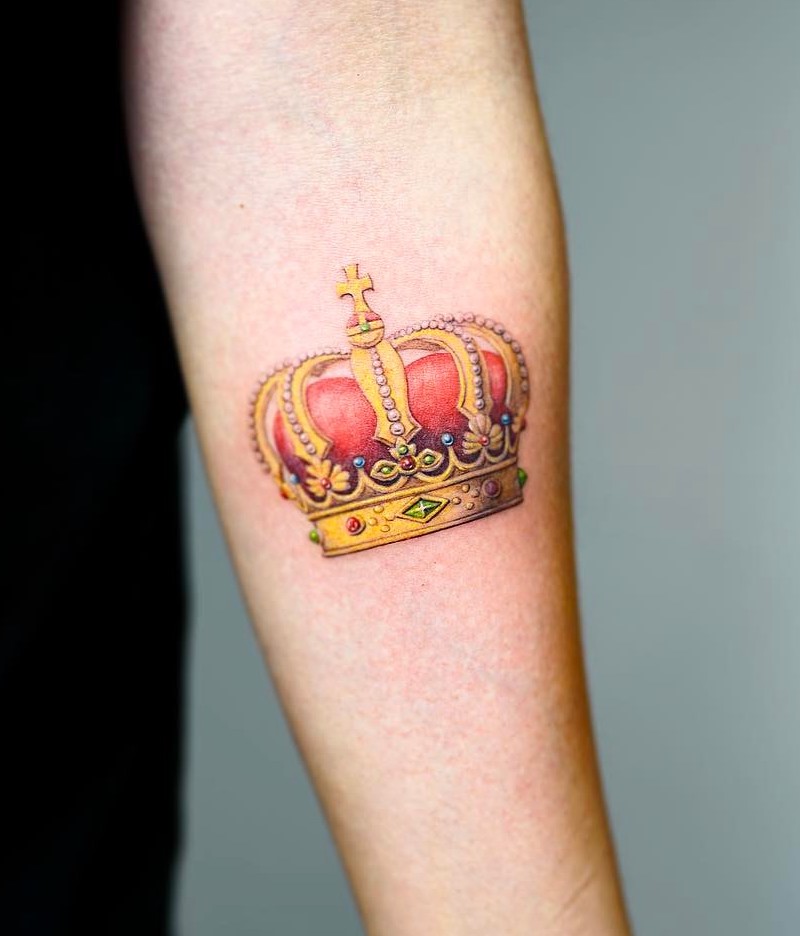 Crown tattoo on the inner forearm