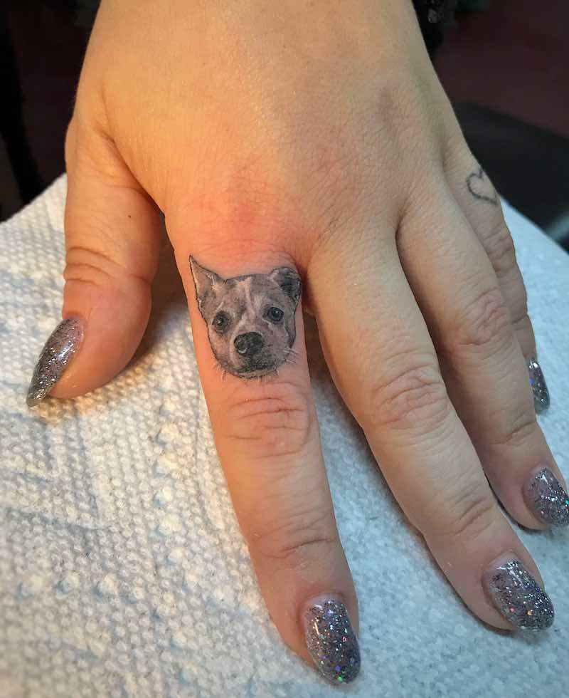 Small Dog Finger Tattoo by Ben Grillo