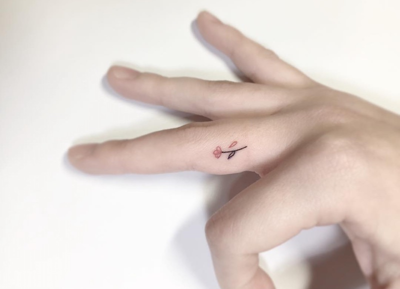 Small Flower Finger Tattoo by Playground Tattoo