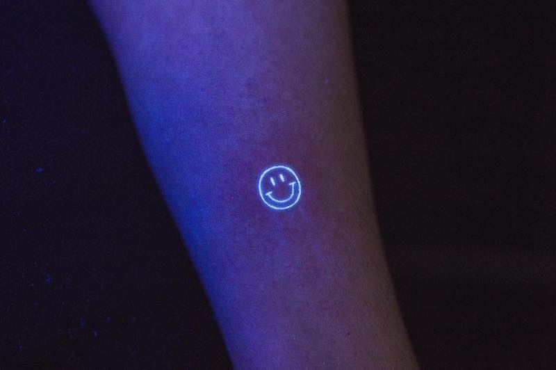 Smiley Face UV Tattoo by Griz